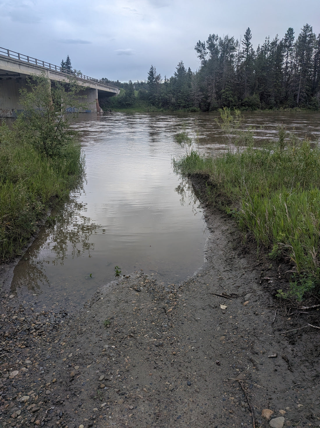 High water on the Red Deer River near the bridge crossing during spring runoff, Alberta gold prospecting conditions