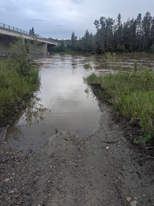 High water on the Red Deer River near the bridge crossing during spring runoff, Alberta gold prospecting conditions