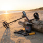Metal detector and accessories on a sandy beach