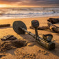 Metal detector on a beach with sunset in the background